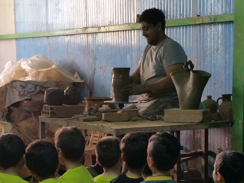 Demonstration in manufacturing on pottery wheel.